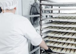 Confectionery production, placing puff pastry buns in freezer for shock freezing