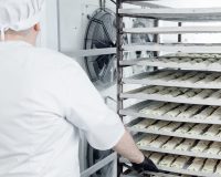 Confectionery production, placing puff pastry buns in freezer for shock freezing